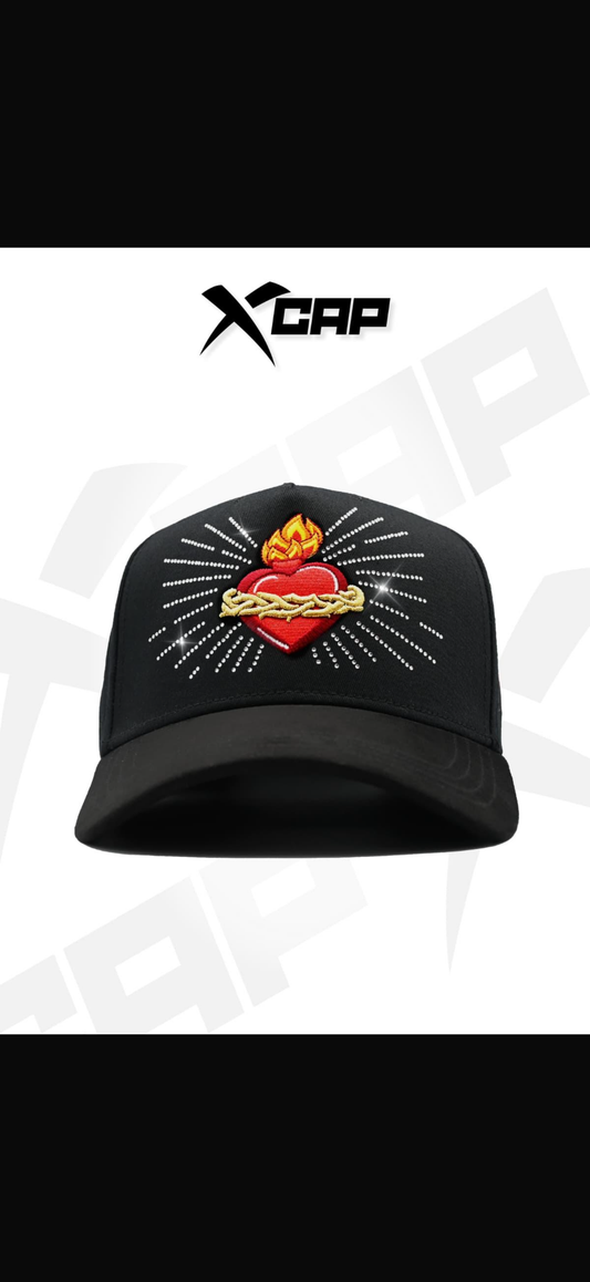 X caps sagrado corazón